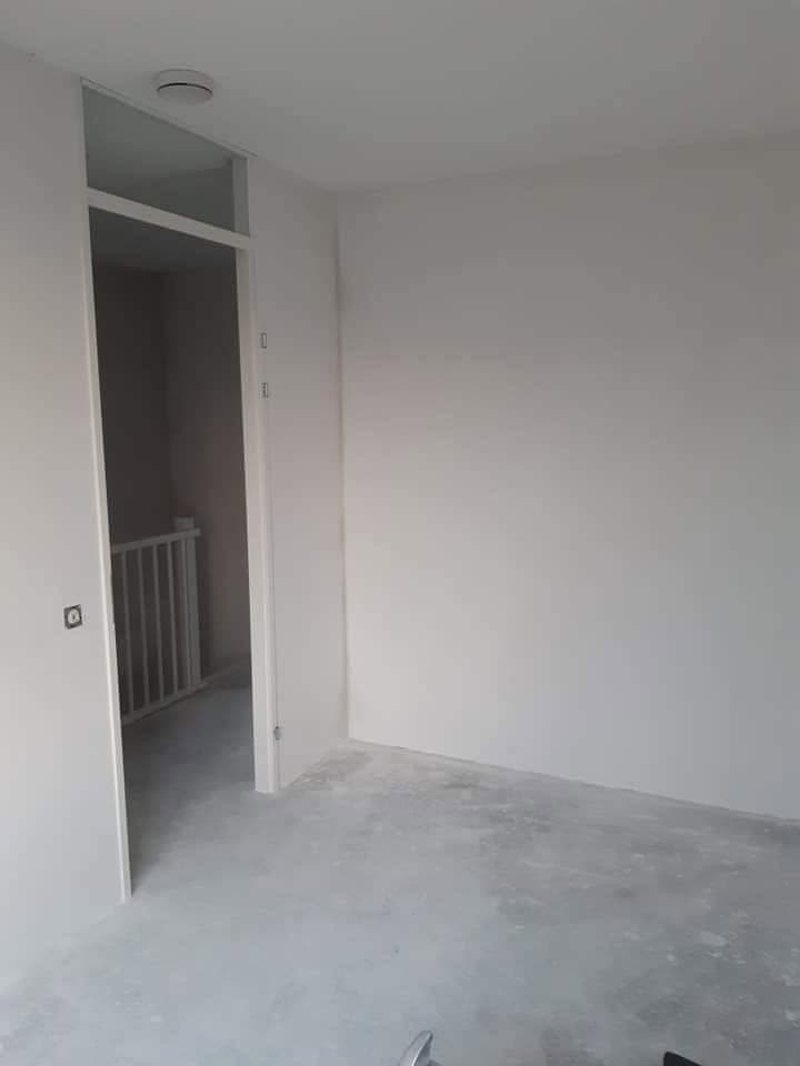 Na: kamer met witte wanden en een deur met bovenlicht. (Facebook, 10 januari 2021)