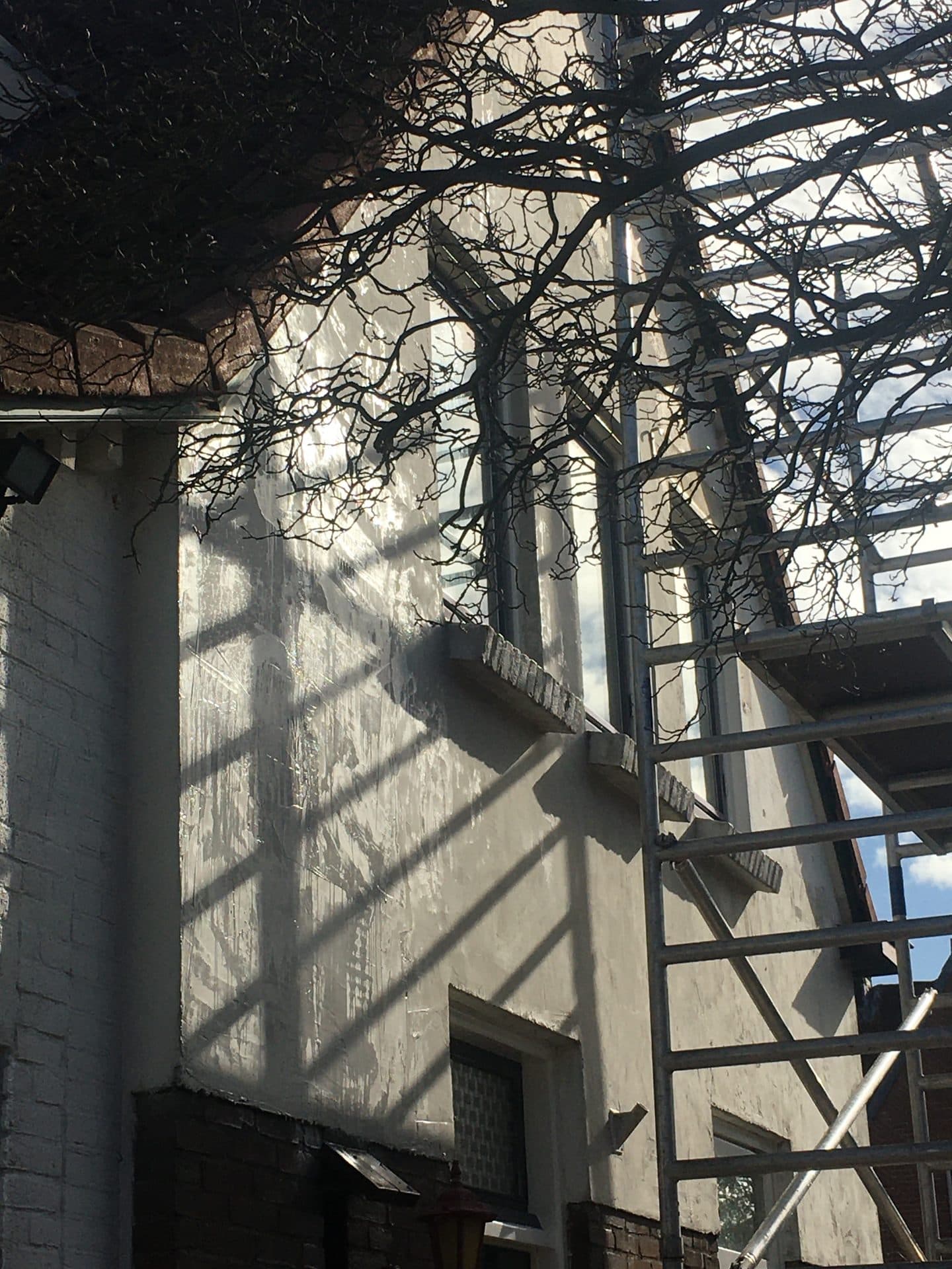 Buitenschilderwerk met dakgoot en dakkapel
